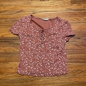 A pink cropped shirt with floral print size L